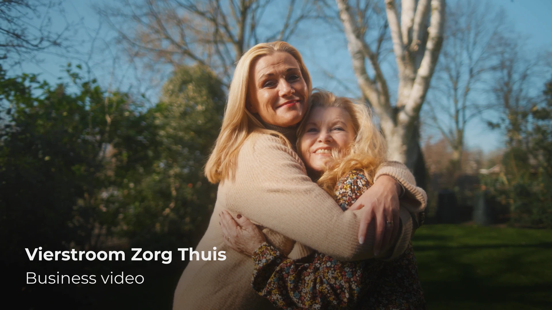 Vrouw en oudere dame in warme omhelzing in tuin